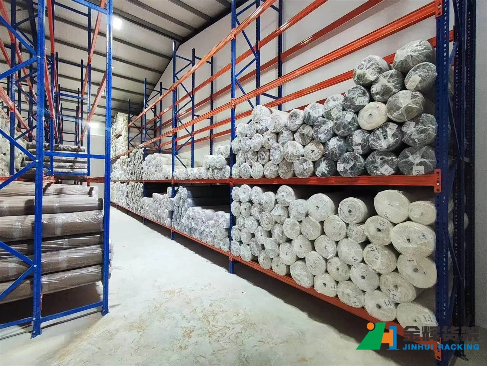 Heavy duty pallet racks storing raw materials and finished goods in a factory warehouse Heavy duty pallet racks storing raw materials and finished goods in a factory warehouse